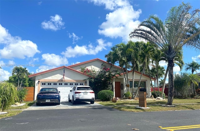 view of front facade with aphalt driveway and an attached garage