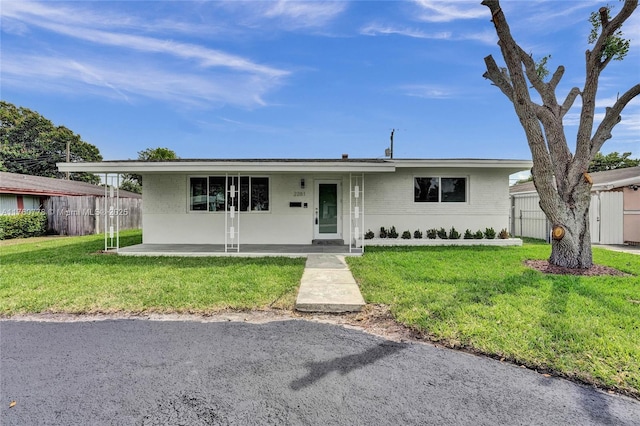 single story home with brick siding, a front lawn, and fence