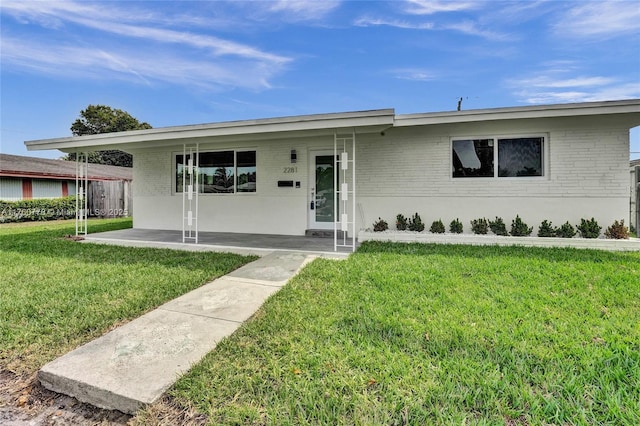 single story home featuring a front lawn and brick siding