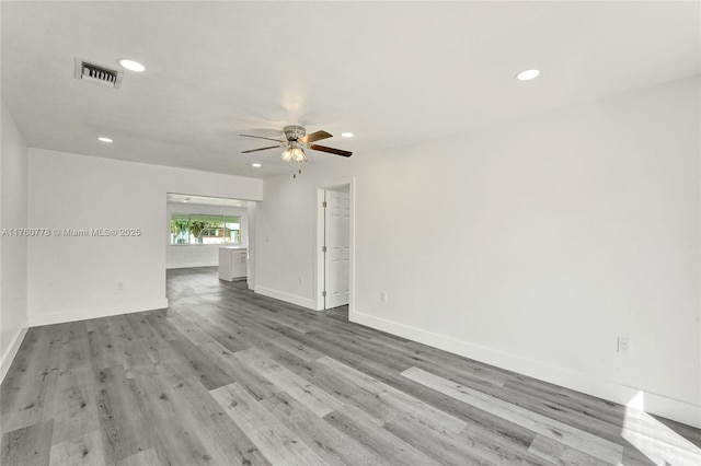 spare room with recessed lighting, visible vents, baseboards, and wood finished floors