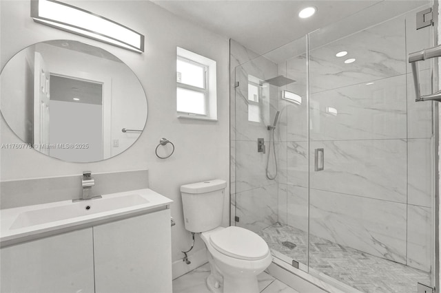 bathroom with vanity, toilet, marble finish floor, and a marble finish shower