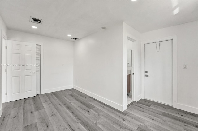 unfurnished room with recessed lighting, visible vents, baseboards, and wood finished floors