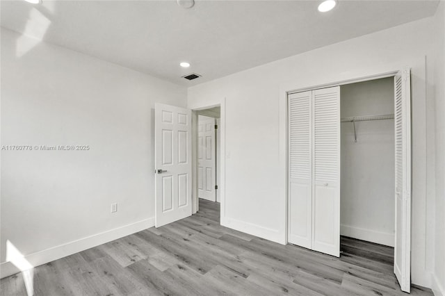 unfurnished bedroom featuring recessed lighting, visible vents, baseboards, and wood finished floors