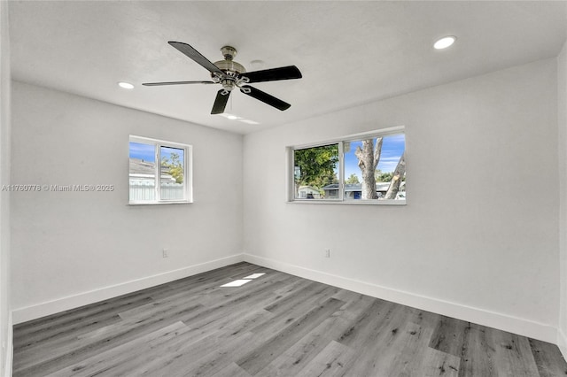 unfurnished room featuring recessed lighting, ceiling fan, baseboards, and wood finished floors