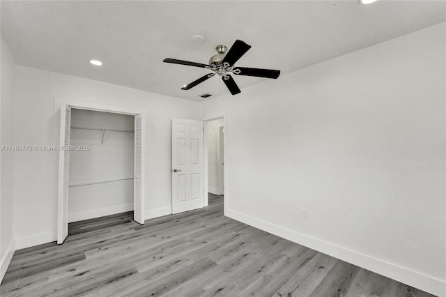 unfurnished bedroom with visible vents, wood finished floors, recessed lighting, a closet, and baseboards