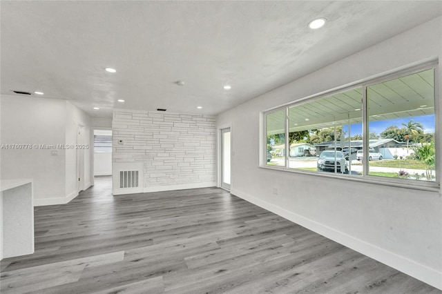 empty room featuring recessed lighting, visible vents, baseboards, and wood finished floors