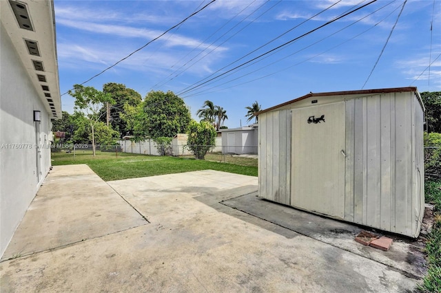 view of patio with a fenced backyard, an outdoor structure, and a shed