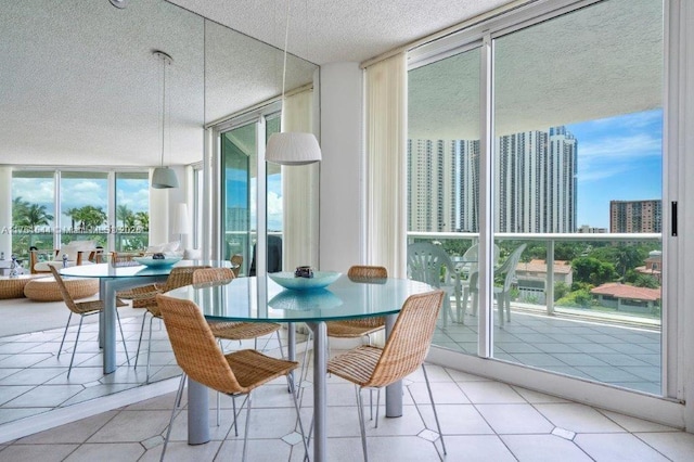 dining room featuring a wall of windows, a textured ceiling, a city view, and tile patterned floors