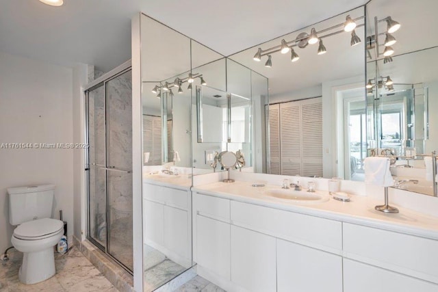 bathroom with toilet, marble finish floor, a stall shower, a closet, and vanity