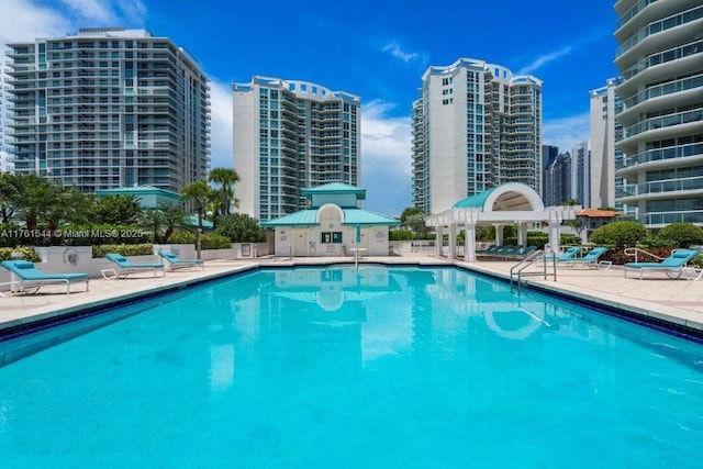 pool with a patio and a view of city