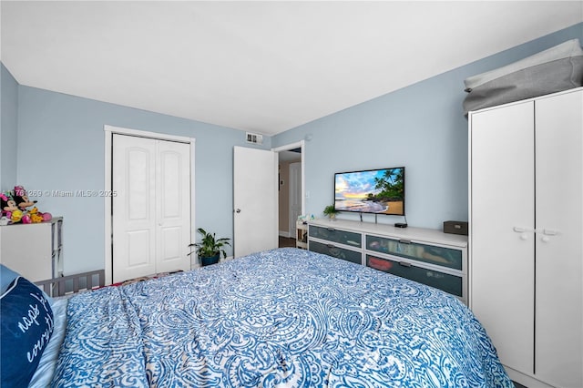bedroom featuring visible vents and a closet