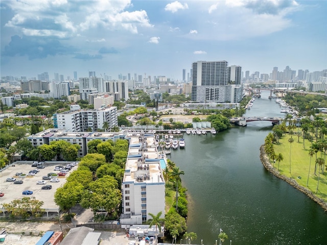 birds eye view of property with a city view and a water view