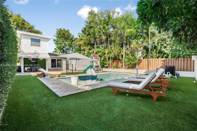 view of swimming pool featuring central air condition unit, a fenced backyard, a yard, a fenced in pool, and a patio area