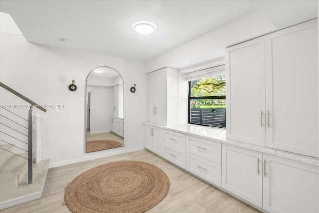 bathroom featuring wood finished floors and baseboards