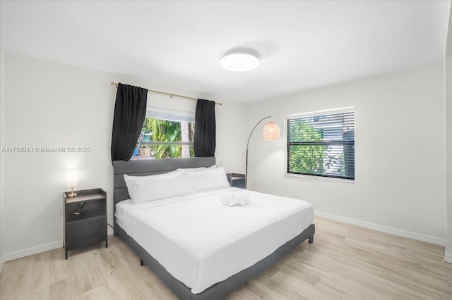 bedroom featuring baseboards and light wood-style floors