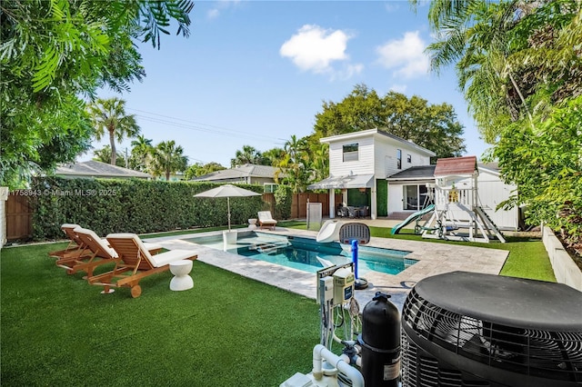 view of pool with central air condition unit, a fenced in pool, a fenced backyard, and a lawn