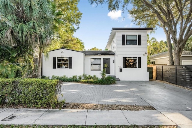 view of front of home with stucco siding and fence