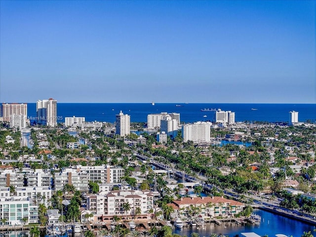 birds eye view of property with a water view and a view of city