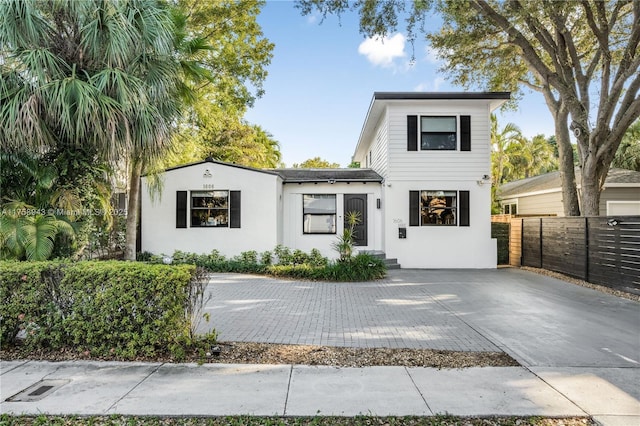 view of front of home with fence and stucco siding