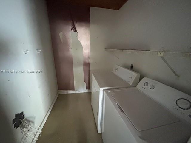 laundry room with washer and dryer, baseboards, and laundry area