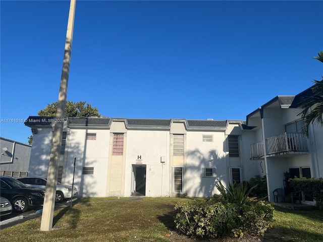 view of building exterior featuring uncovered parking