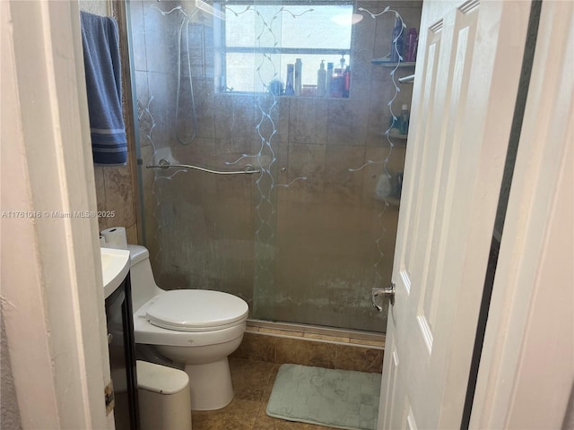 full bath with vanity, toilet, a stall shower, and tile patterned flooring