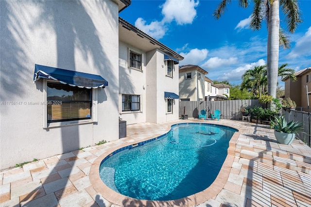 view of pool featuring a patio, a fenced backyard, and a fenced in pool