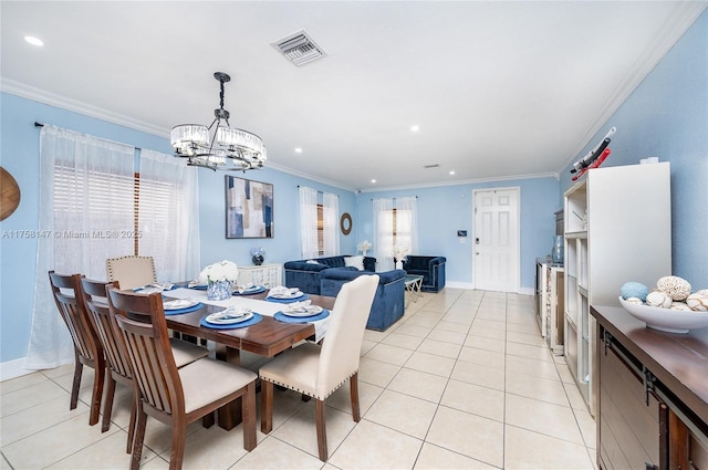 dining area with light tile patterned flooring, visible vents, and ornamental molding