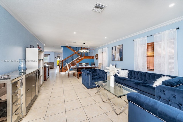 living area featuring light tile patterned floors, visible vents, ornamental molding, and stairs