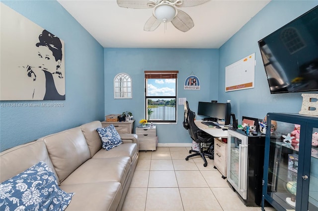 home office with tile patterned flooring, a ceiling fan, and baseboards