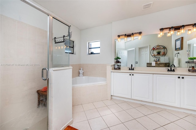 bathroom featuring visible vents, a garden tub, a stall shower, a sink, and tile patterned flooring