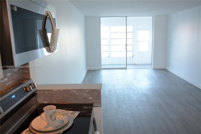 interior space with baseboards and wood finished floors