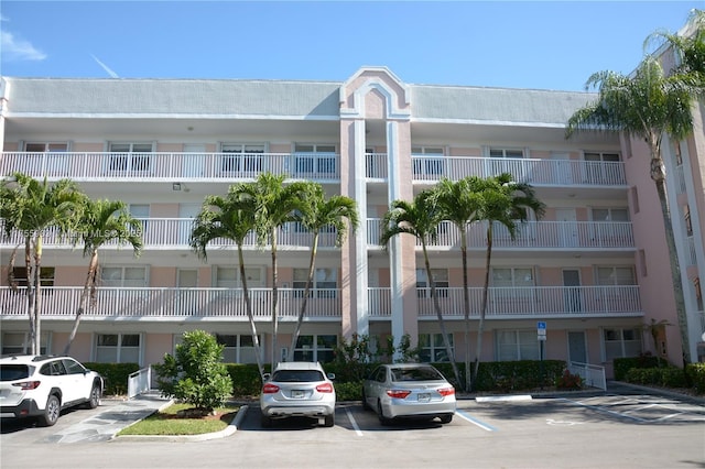 view of building exterior with uncovered parking