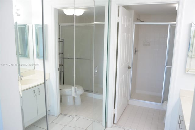 full bath with a stall shower, toilet, and vanity