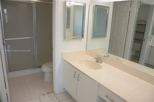 full bath featuring vanity, tile patterned floors, toilet, and a stall shower