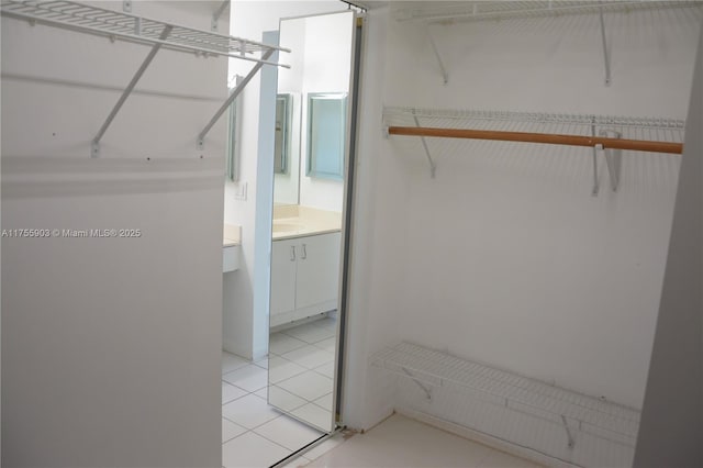 spacious closet featuring light tile patterned floors