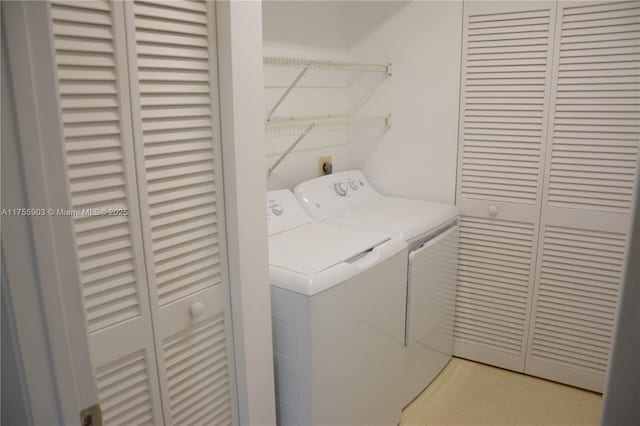 clothes washing area with light floors, laundry area, and washing machine and clothes dryer