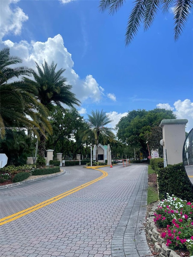 view of street featuring curbs and a gated entry