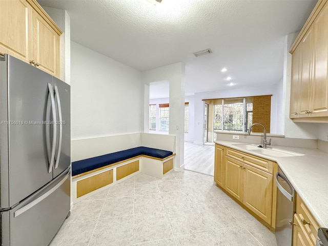5737 NW 119th Dr Unit 5737, Coral Springs, FL 33076 - kitchen featuring light brown cabinetry, a sink, a textured ceiling, stainless steel appliances, and light countertops