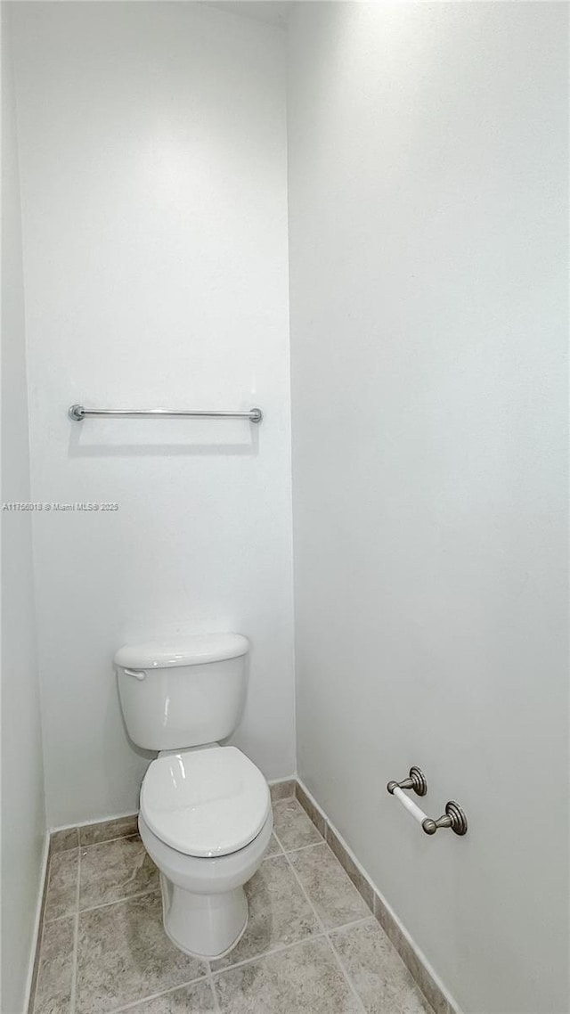 5737 NW 119th Dr Unit 5737, Coral Springs, FL 33076 - bathroom featuring tile patterned floors, toilet, and baseboards