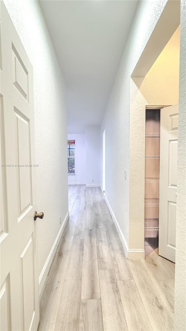 5737 NW 119th Dr Unit 5737, Coral Springs, FL 33076 - corridor with baseboards, wood finished floors, and a textured wall