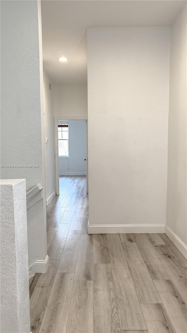 5737 NW 119th Dr Unit 5737, Coral Springs, FL 33076 - corridor with baseboards and light wood-style floors