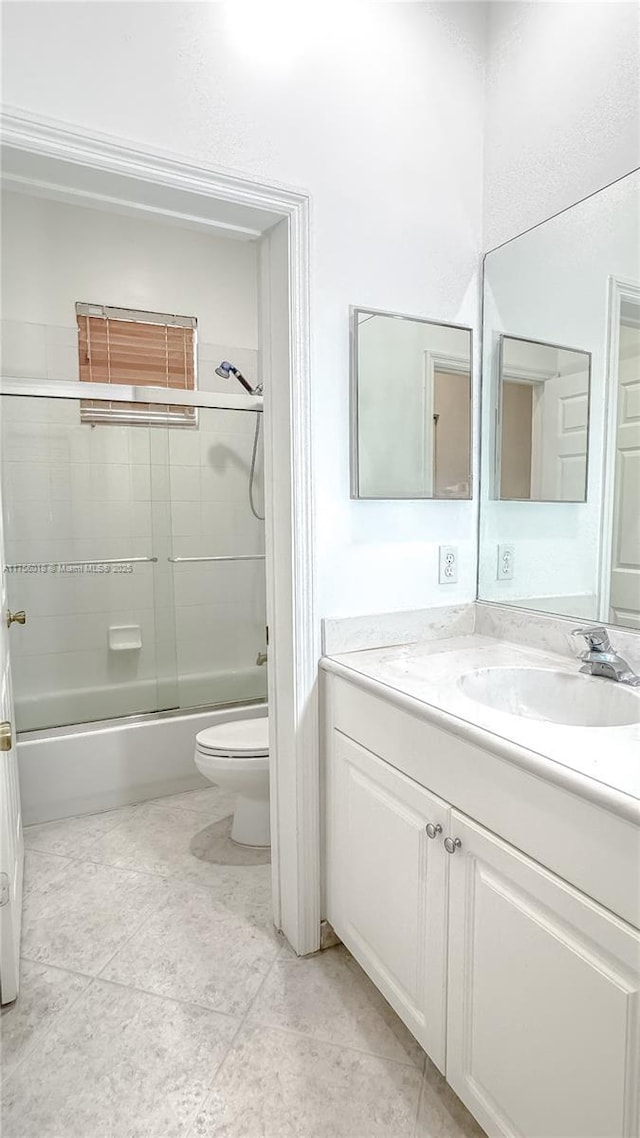 5737 NW 119th Dr Unit 5737, Coral Springs, FL 33076 - full bathroom featuring tile patterned floors, enclosed tub / shower combo, toilet, and vanity