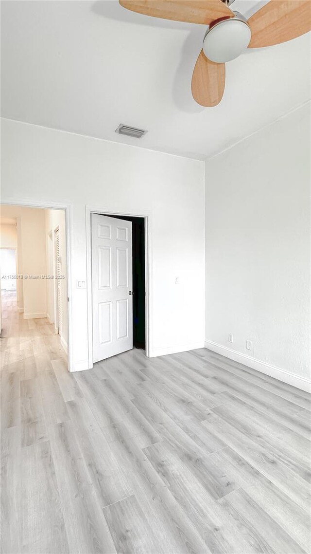 5737 NW 119th Dr Unit 5737, Coral Springs, FL 33076 - unfurnished bedroom with a ceiling fan, baseboards, light wood-type flooring, and a closet