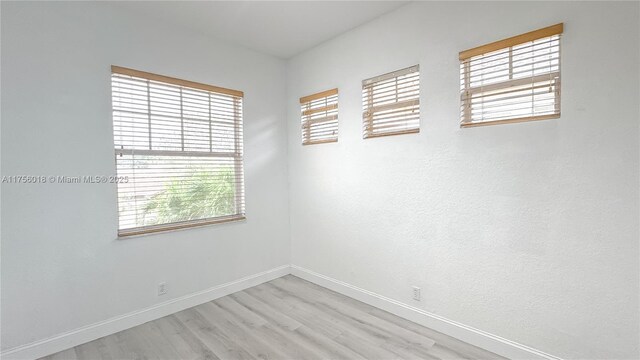 5737 NW 119th Dr Unit 5737, Coral Springs, FL 33076 - unfurnished room featuring baseboards and light wood finished floors