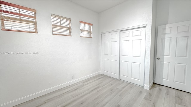 5737 NW 119th Dr Unit 5737, Coral Springs, FL 33076 - unfurnished bedroom with a closet, light wood-type flooring, and baseboards