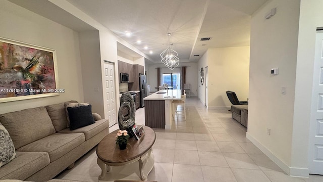 living area featuring visible vents, recessed lighting, light tile patterned flooring, baseboards, and a chandelier