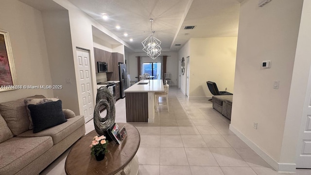 8045 NW 104th Ave Unit 35, Doral, FL 33178 - living room with light tile patterned floors, baseboards, and a chandelier