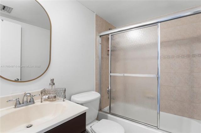 full bathroom with vanity, toilet, visible vents, and enclosed tub / shower combo