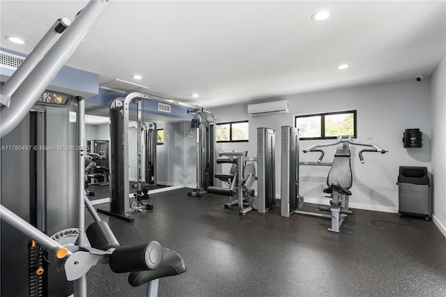 gym with a wall unit AC, recessed lighting, baseboards, and visible vents